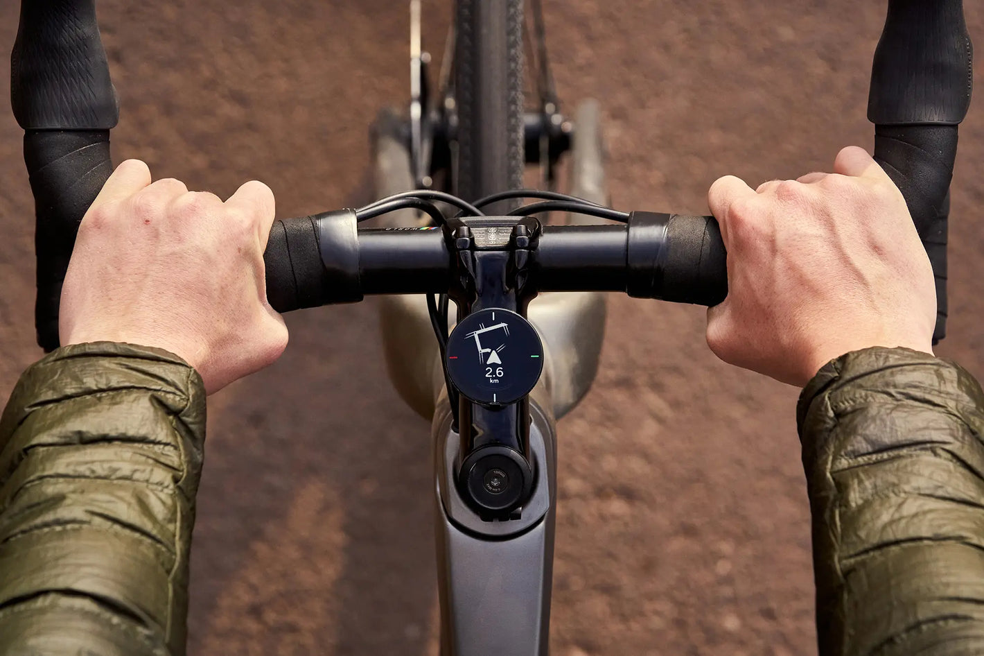 two hands holding bicycle handle bars with Beeline Velo two mounted in the middle