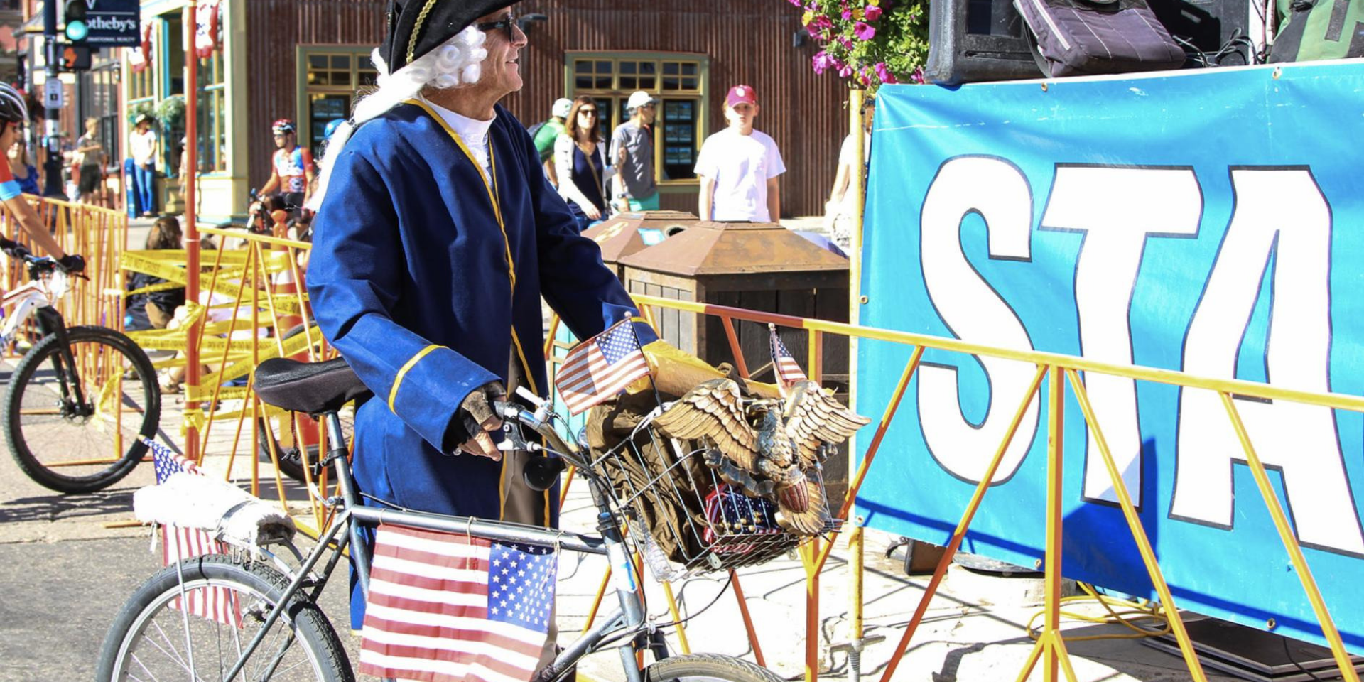 Man in American patriotic clothing on a bicycle