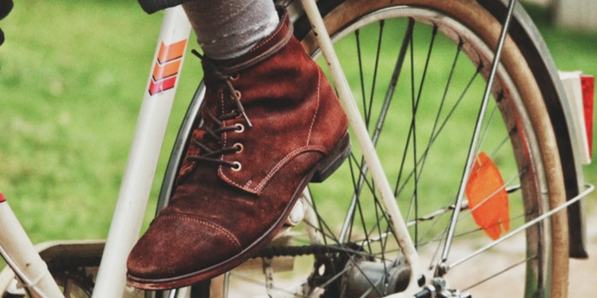 close up of person cycling with brown suede shoes